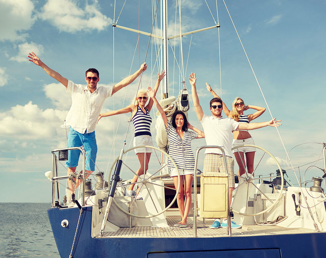 Members celebrating on the stern of a sailing yacht