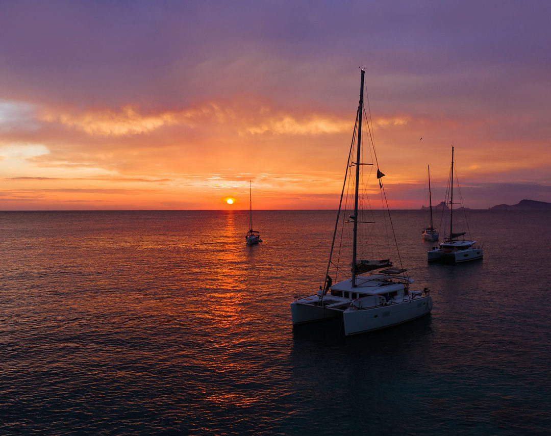Catamarans at anchor at sunset