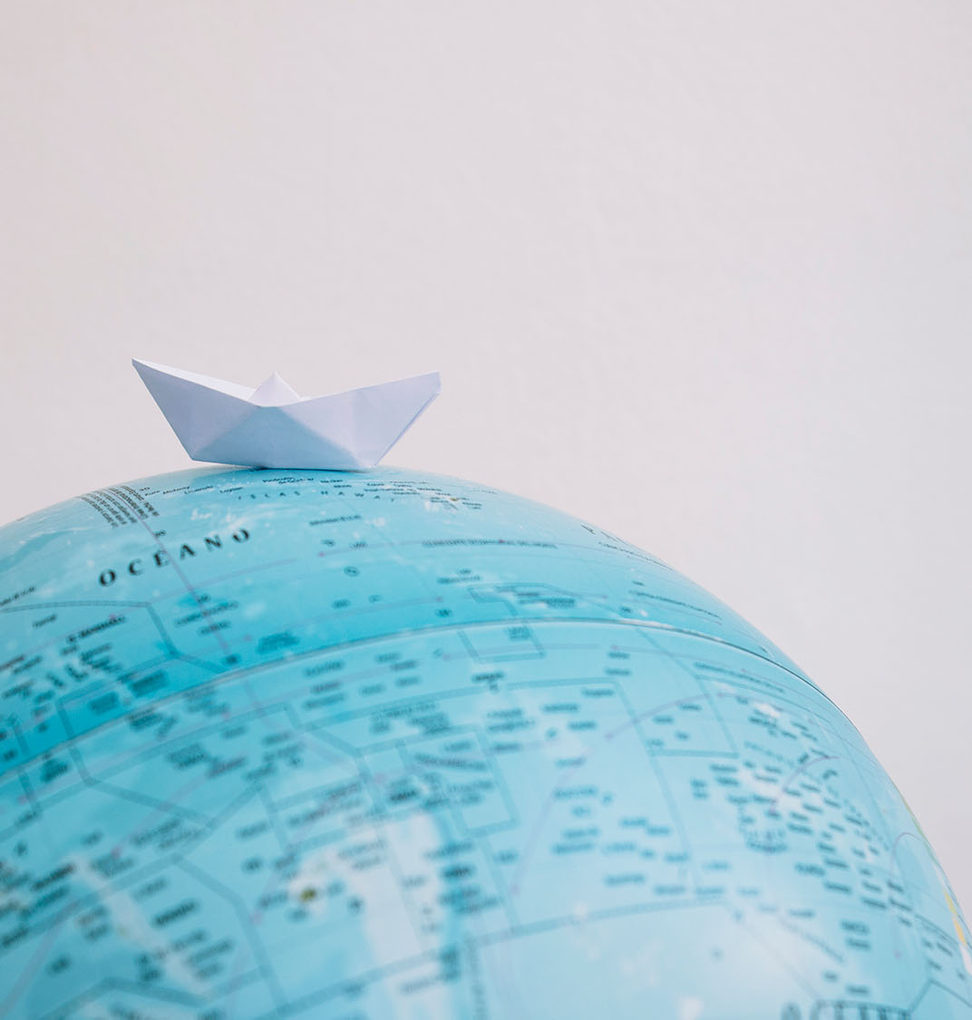 Paper boat on a globe